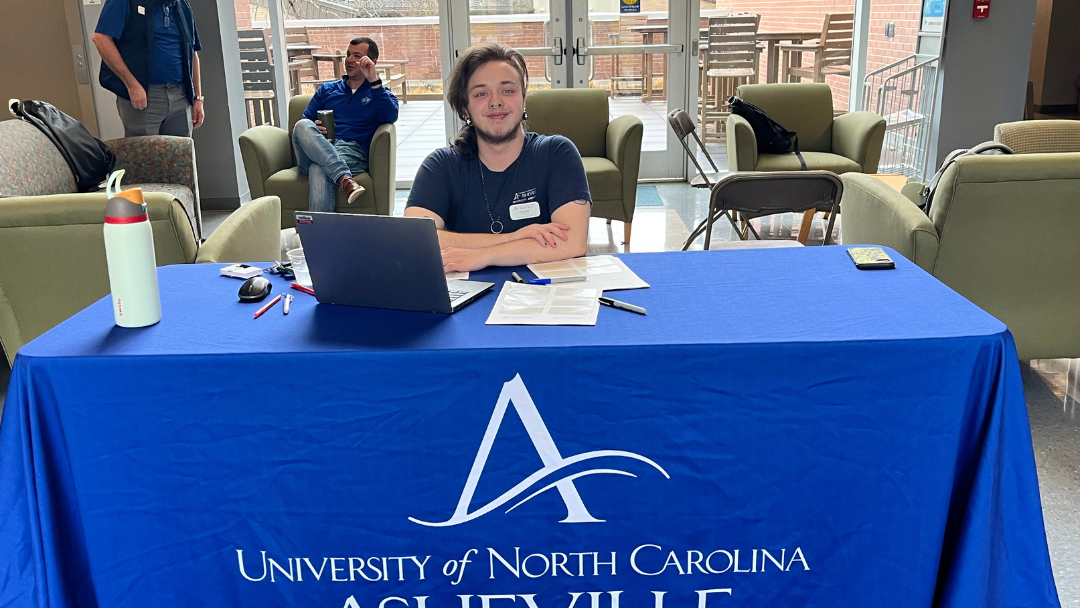 UNCA staff member at table during 2024 FAFSA Day