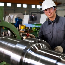 Male industrial machinery mechanic in hard hat