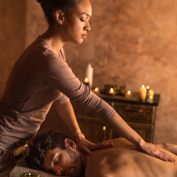 Female massage therapist massaging a client